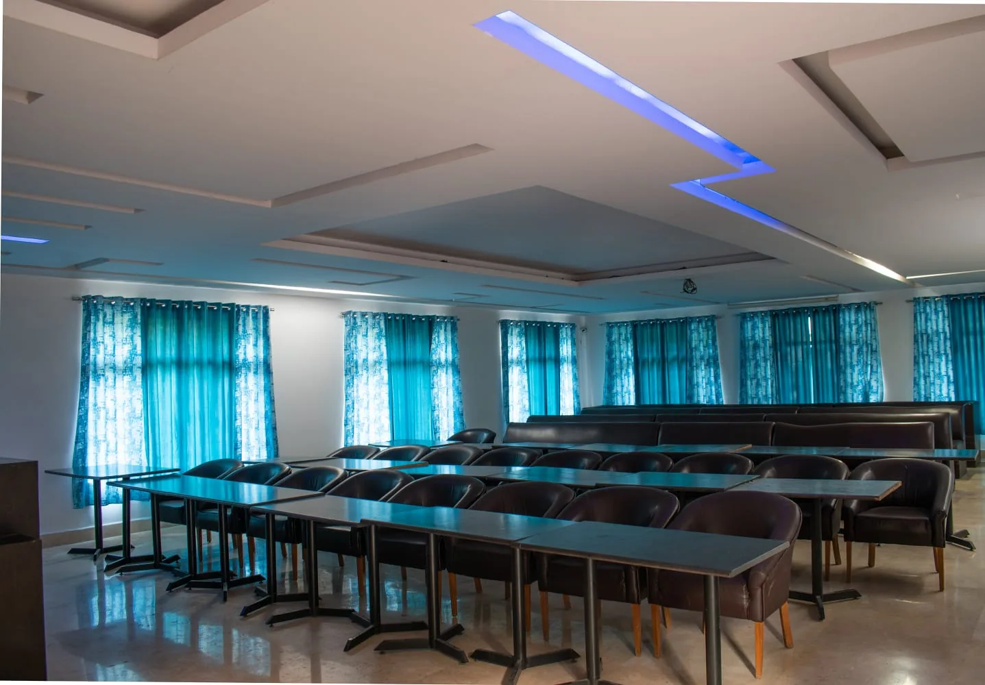 Modern Conference Hall at Vaapi Comfort Inn with professional seating and LED lighting
